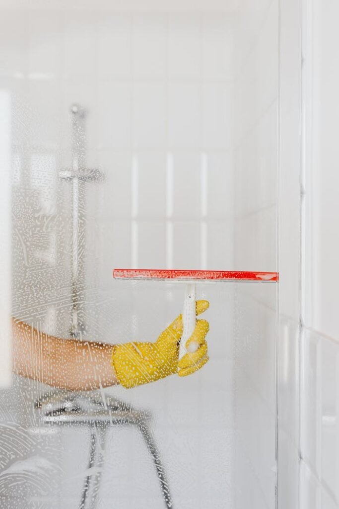 pexels-photo-4239091 Crop person cleaning glass shower unit
